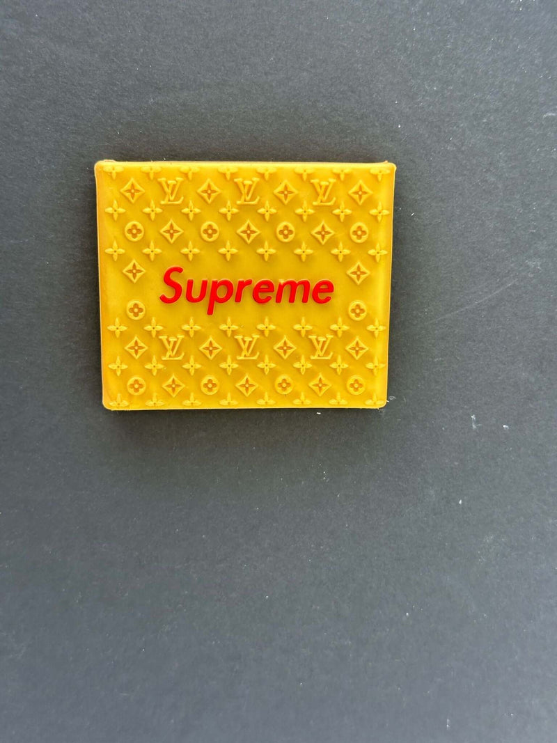 Yellow Supreme clipper grips featuring a branded design for enhanced barber precision and comfort.