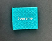 Blue Supreme grip with embossed Louis Vuitton pattern for stylish and functional use.
