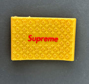 Yellow Supreme clipper grips featuring a branded design for enhanced barber precision and comfort.