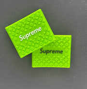 Green Supreme grips with logo design for barbers, enhancing precision and comfort during grooming.
