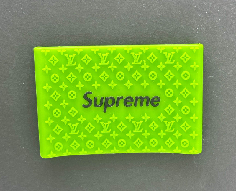 Green Supreme clipper grip featuring embossed Louis Vuitton patterns for enhanced control and precision in barbering.