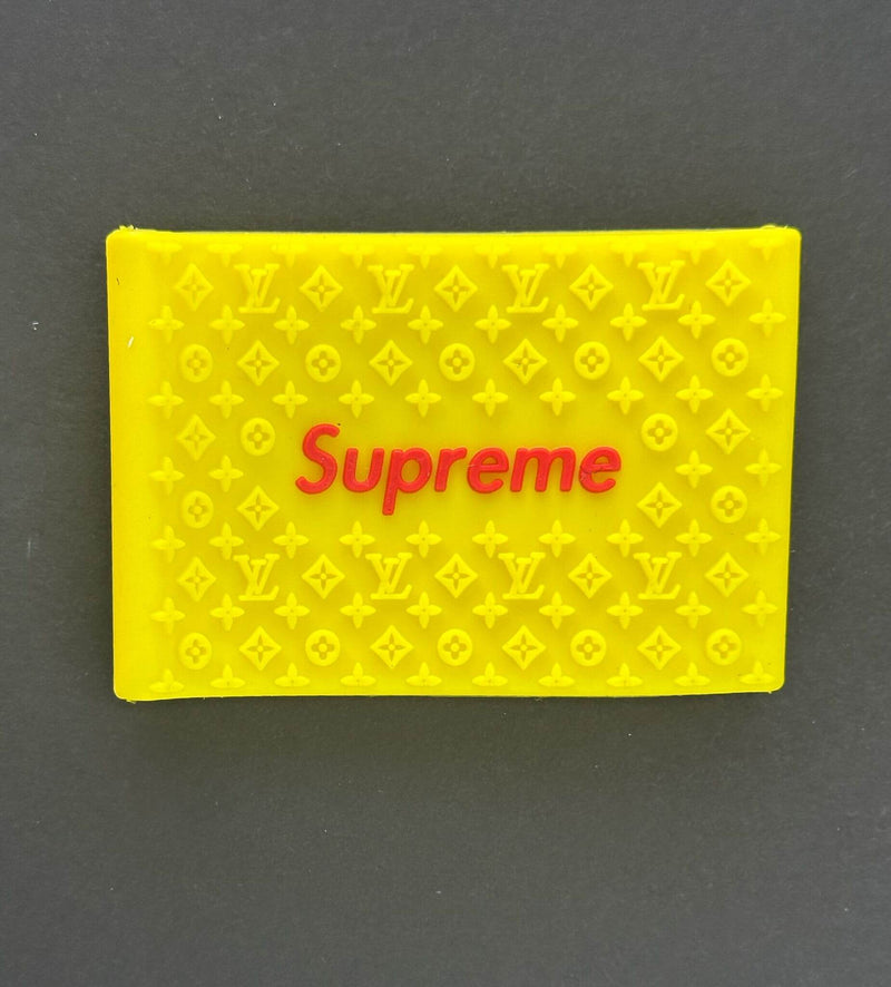 Yellow Supreme clipper grips featuring a branded design for enhanced barber precision and comfort.
