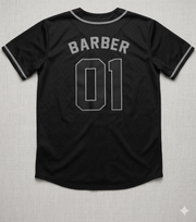 Black baseball jersey with 'BARBER 01' text on a textured gray background