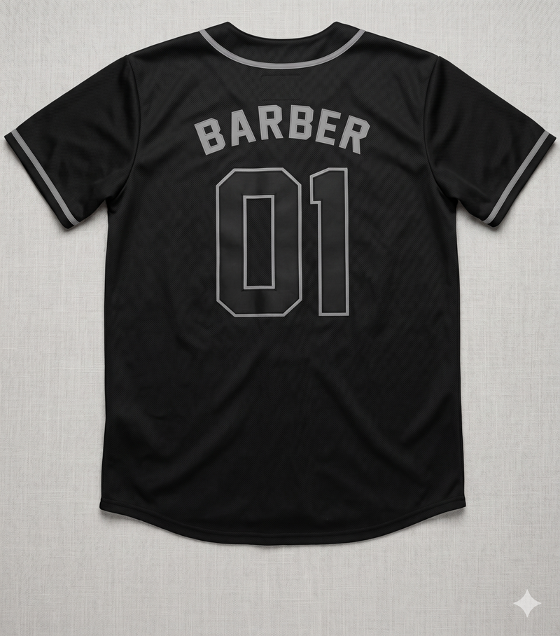 Black baseball jersey with 'BARBER 01' text on a textured gray background