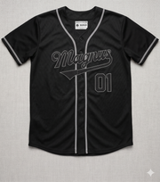 Black baseball jersey with 'Magnus' and number '01' on a gray background