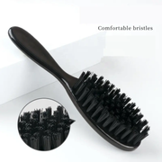 Black hairbrush with close-up of bristles on a white background