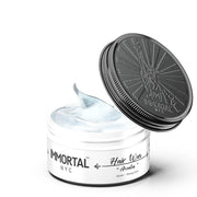 Immortal NYC pomades hair wax jar with lid open, showcasing strong hold and styling product.