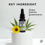 Hemp oil dropper bottle with a sunflower and cannabis leaves on a white background