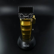 Stylecraft Saber 2.0 Cordless Clipper showcasing its gold design on a sleek charging base.