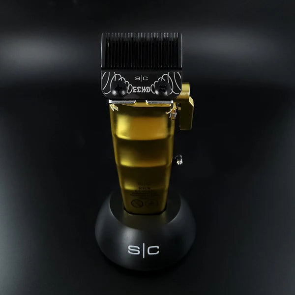 Stylecraft Saber 2.0 Cordless Clipper showcasing its gold design on a sleek charging base.