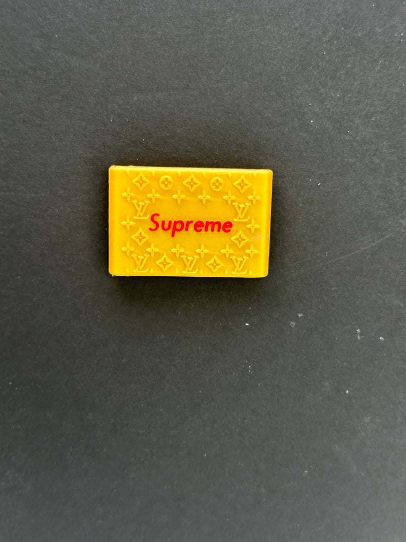 Yellow Supreme clipper grips featuring a branded design for enhanced barber precision and comfort.